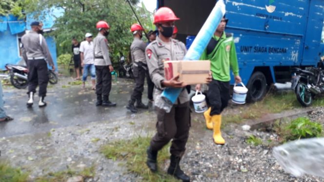 
					Personil Brimob dan Warga Gotong Royong Dirumah Korban Tertimpa Pohon
